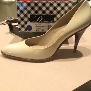 Delman cream pumps with tortoise heels and gold bead detailing